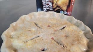 unbaked blueberry pie with flaky crust