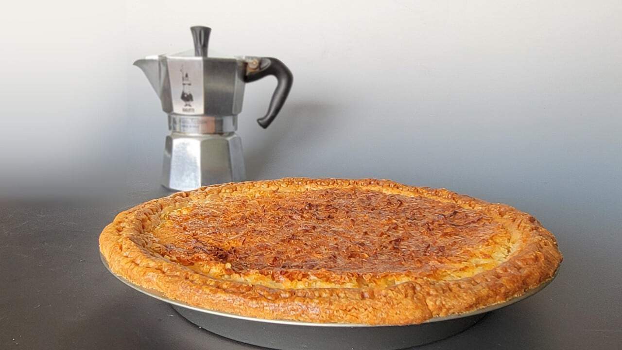 coconut custard pie with espresso maker in background