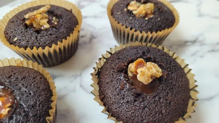 cupcake with holes filled with hazelnuts and caramel