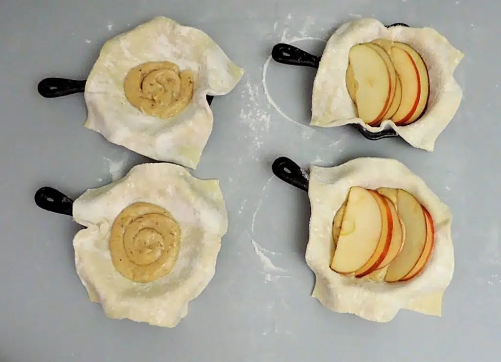 placing walnut frangipane and apples in pastry