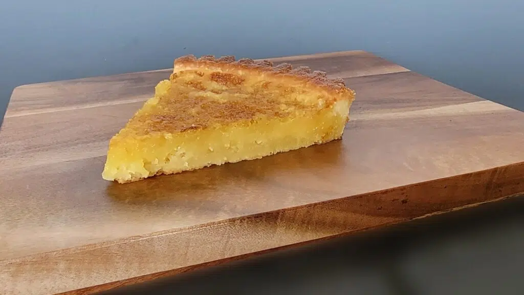 classic lemon tart slice on cutting board