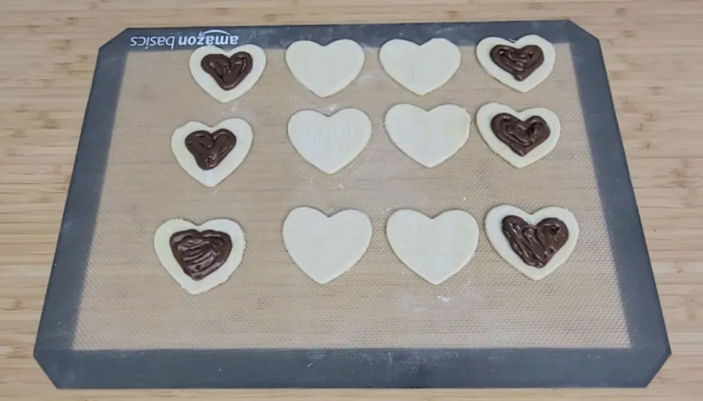 filling heart shaped desserts with chocolate hazelnut spread