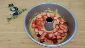 adding fresh strawberries to coffee cake