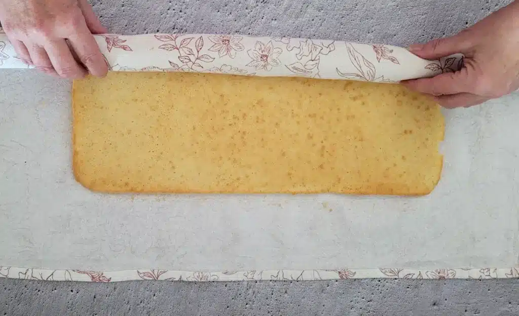 rolling Swiss cake roll in a towel