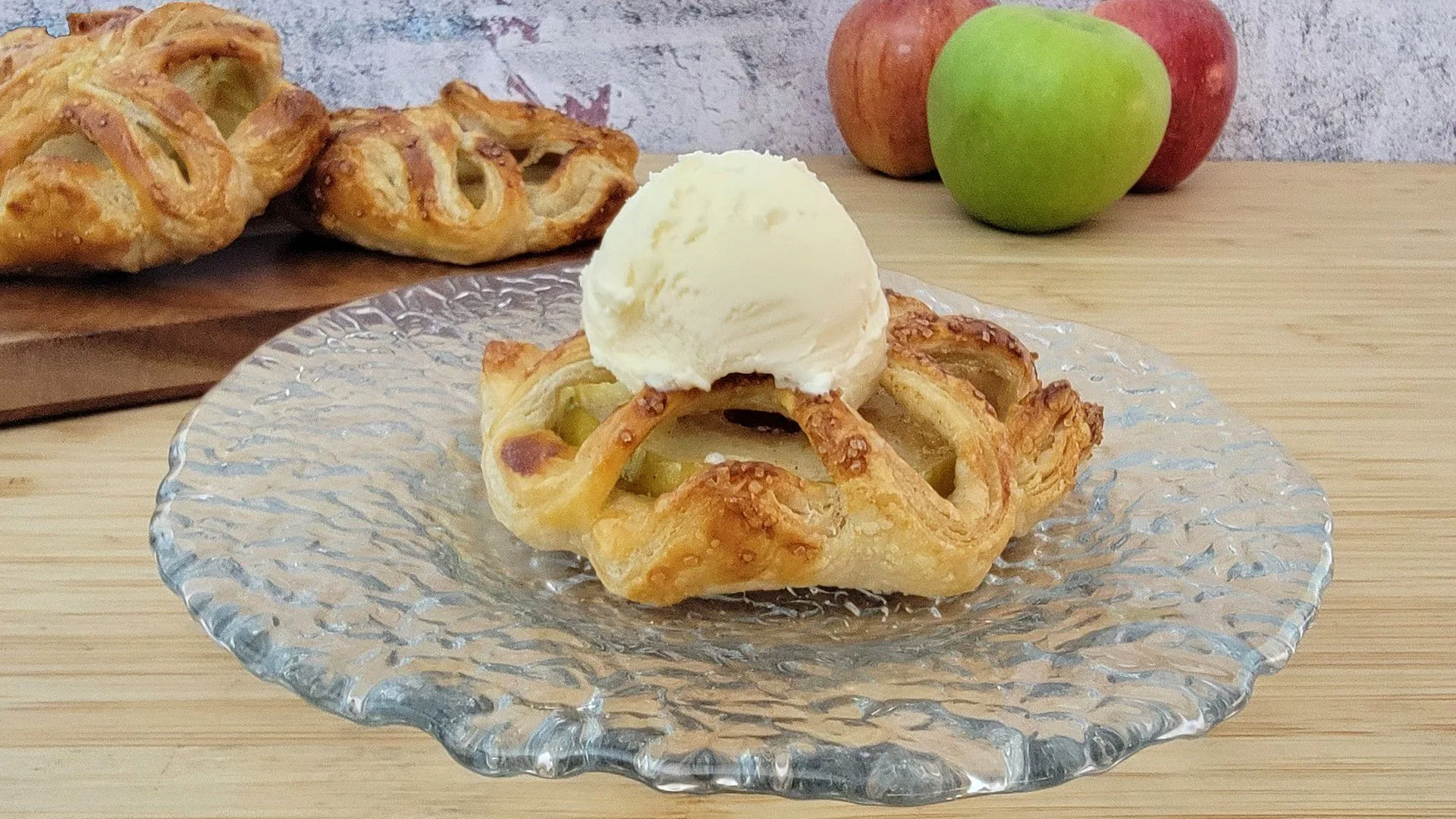 mini apple pie on a plate with ice cream