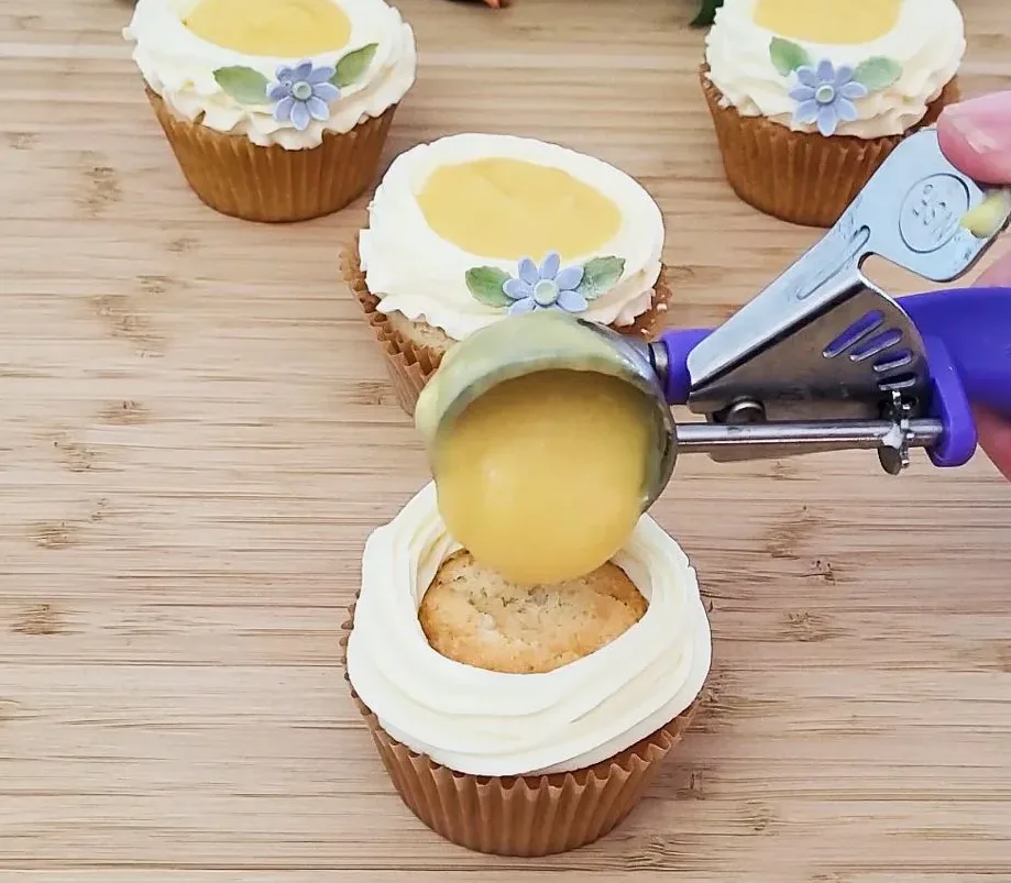 filling cupcake with mango curd