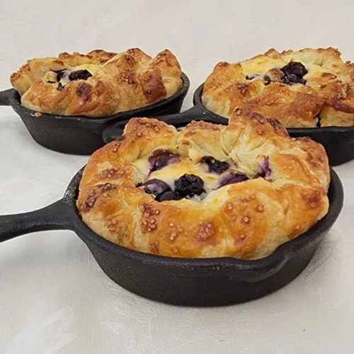 mini blueberry pies in cast iron skillets