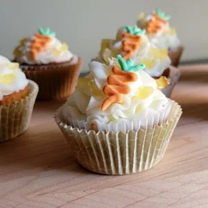 carrot cupcakes with candied pineapple filling and cream cheese frosting
