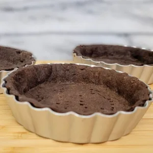 chocolate pie and tart dough in pie pans
