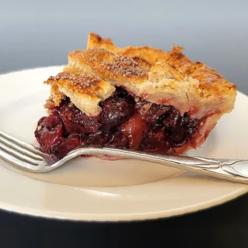 slice of fresh cherry pie on a plate