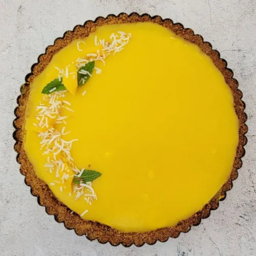 mango cream tart with graham crust overhead view