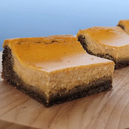 pumpkin cheesecake bars on a platter