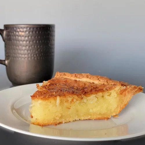 slice of old fashioned coconut custard pie on a plate