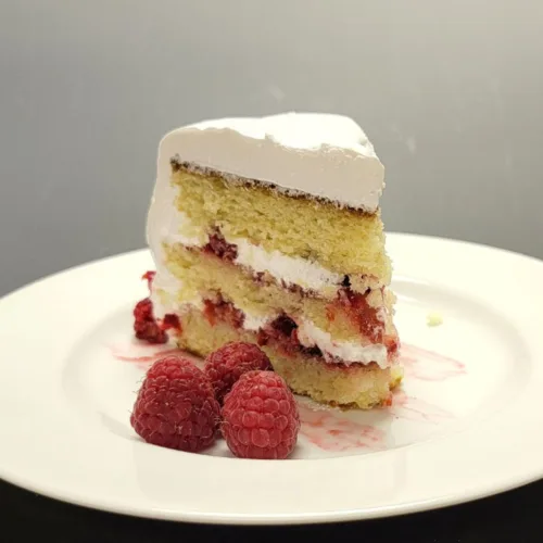 slice of vanilla raspberry cake on a plate