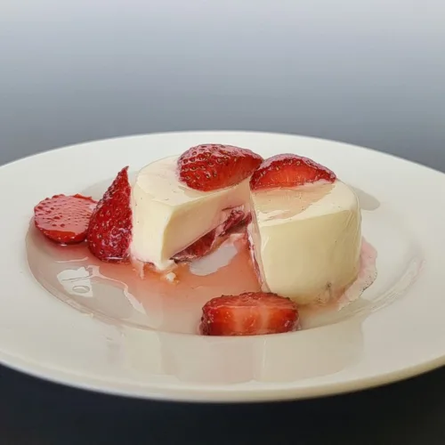 individual serving of strawberry panna cotta on a plate