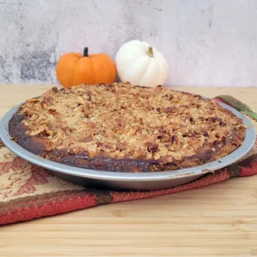 baked pumpkin walnut pie with pumpkin decorations
