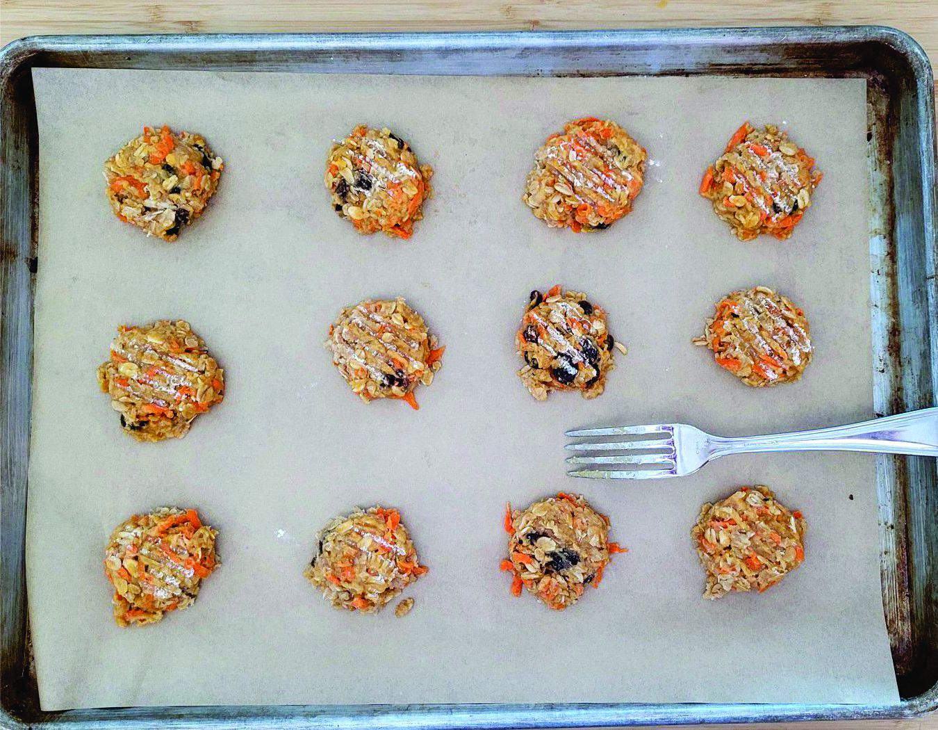 vegan carrot cake cookies scooped onto a baking sheet