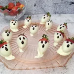 white chocolate covered strawberries with chocolate decorations for Halloween ghosts