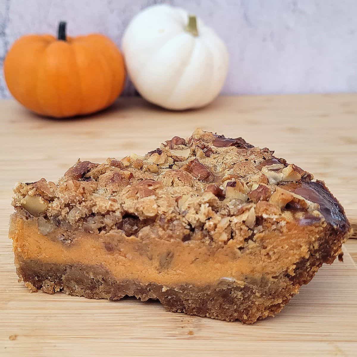 slice of walnut pumpkin pie on a wooden platter