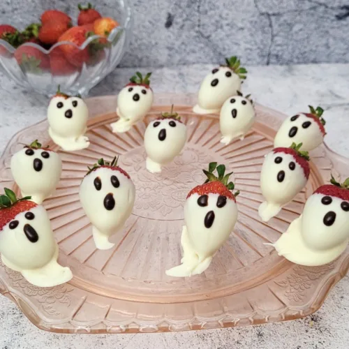 strawberries covered in white chocolate and decorated to look like ghosts