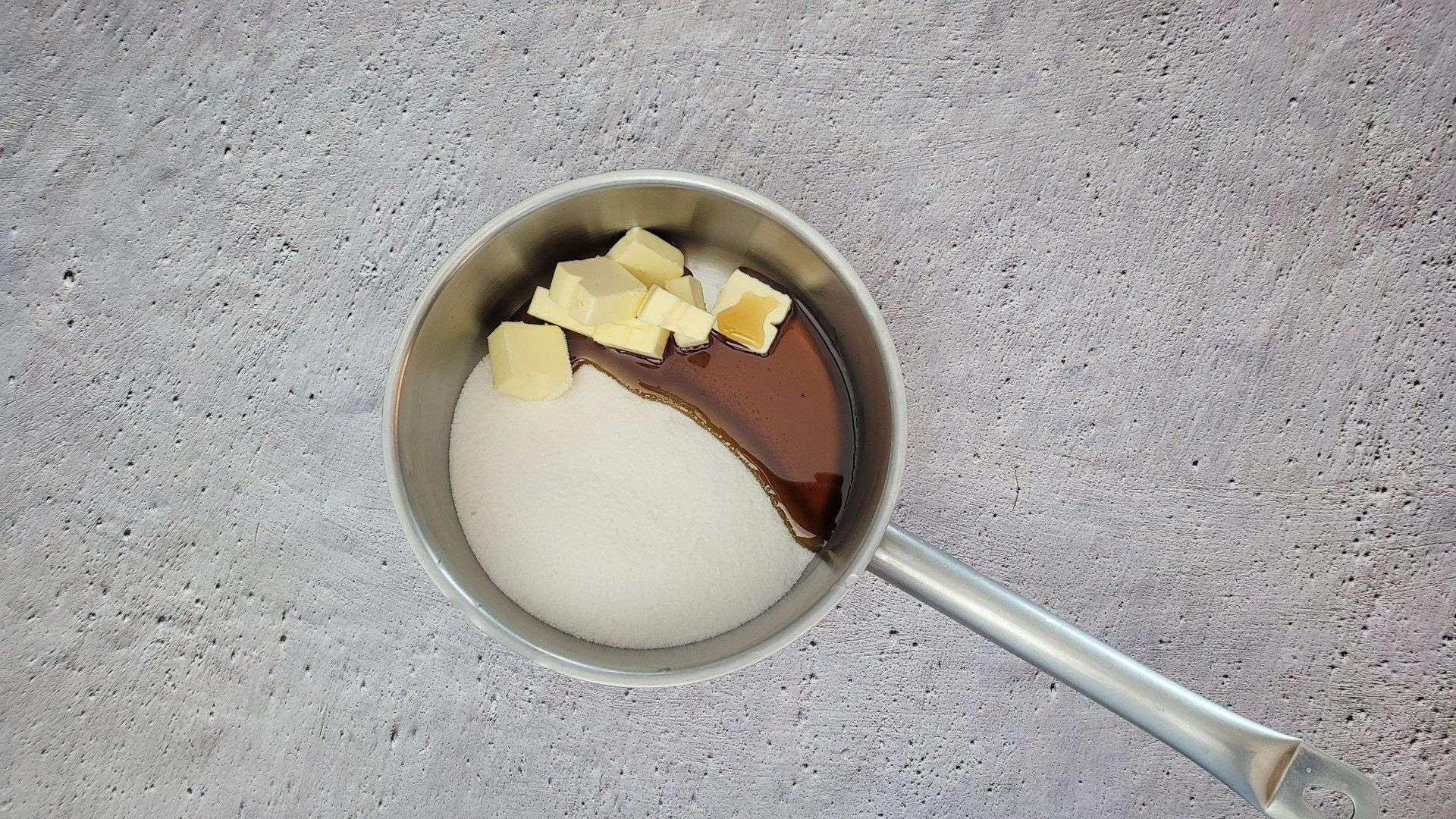 ingredients to make caramel in a saucepan