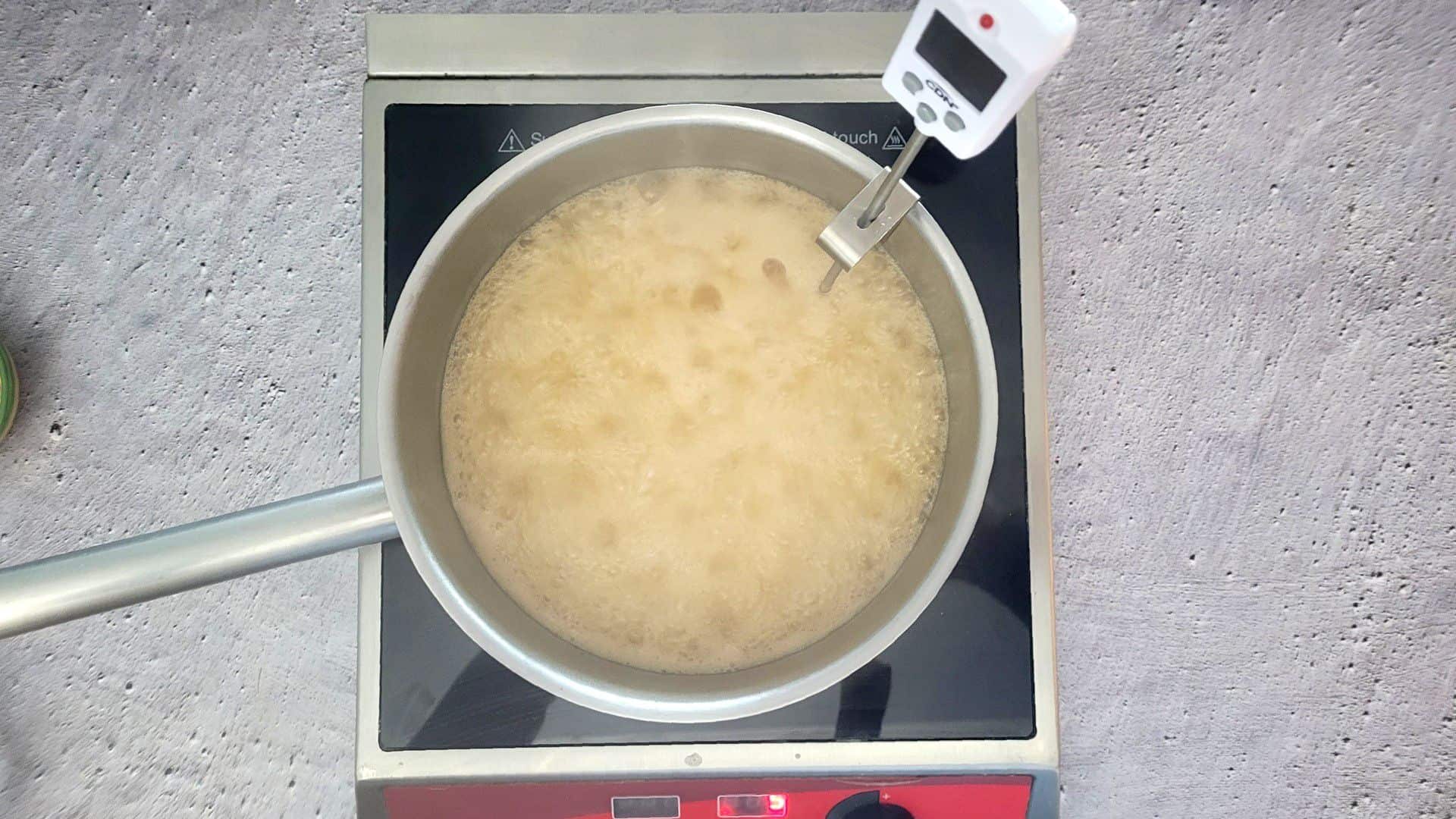 saucepan with thermometer to measure caramel temperature