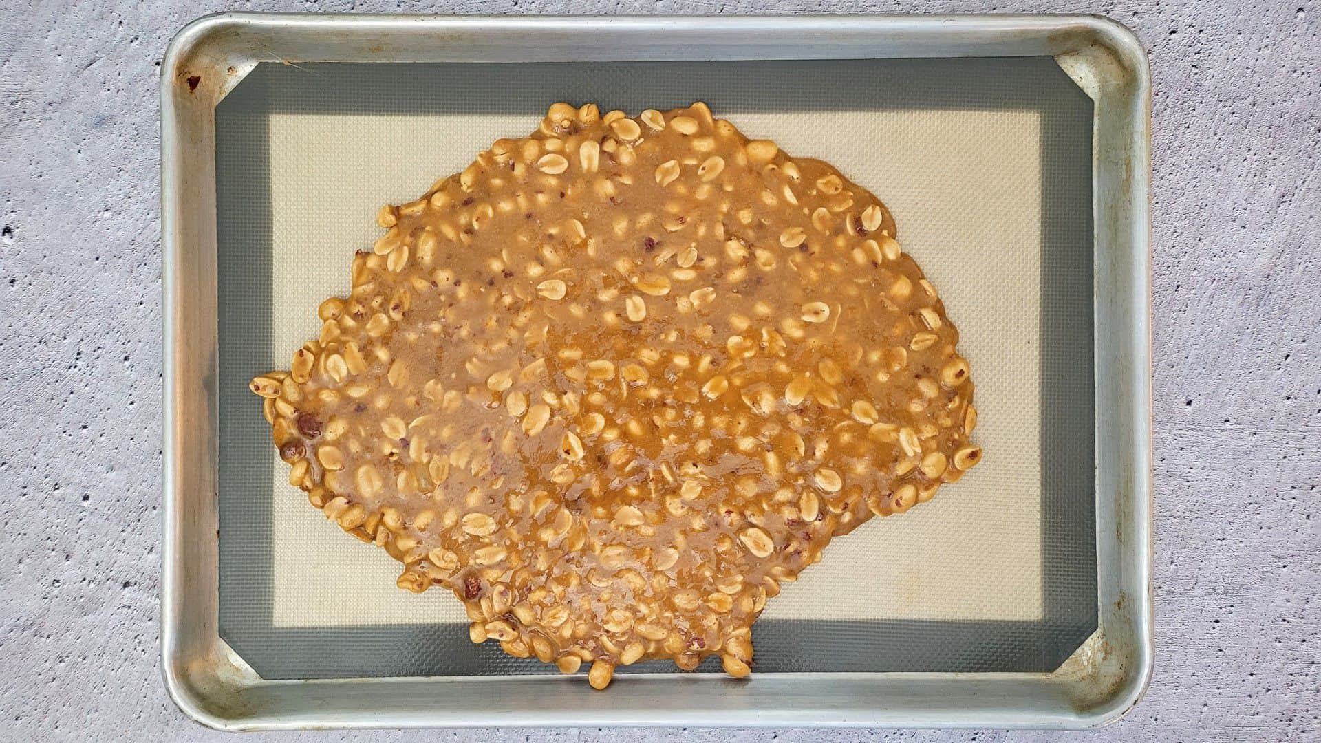 peanut brittle cooling on a sheetpan