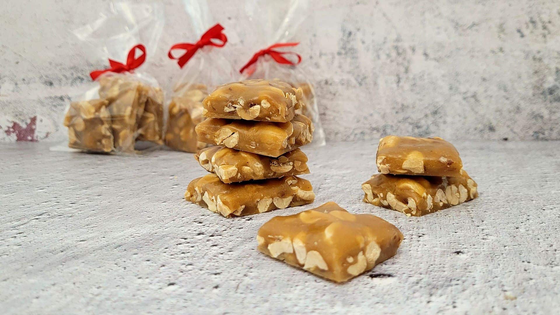 peanut brittle in bags with a red bow for gifts