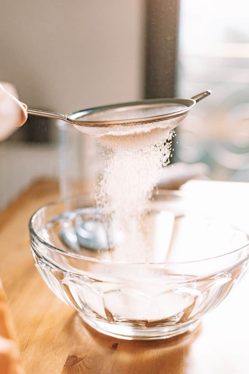 sifting flour into a glass bowl
