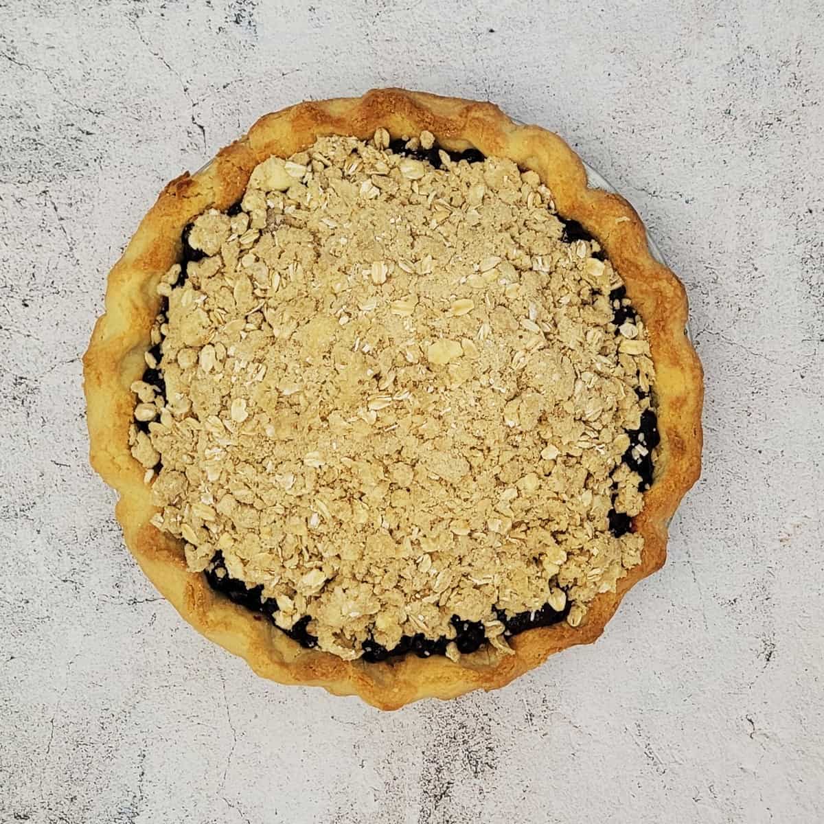 overhead view of blueberry crumble pie ready for baking