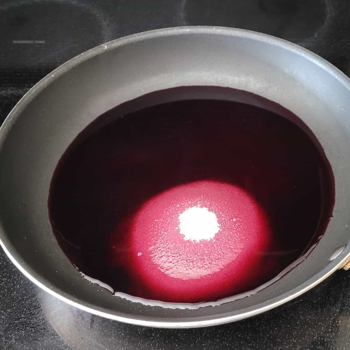 blueberry juice and sugar in a saucepan