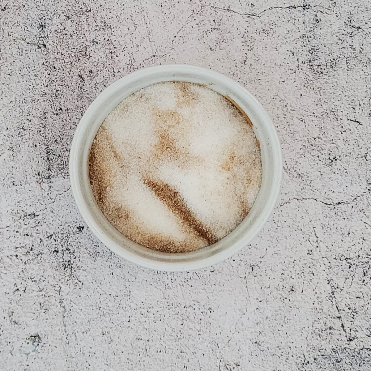 cinnamon and sugar mixed together in a white ramekin