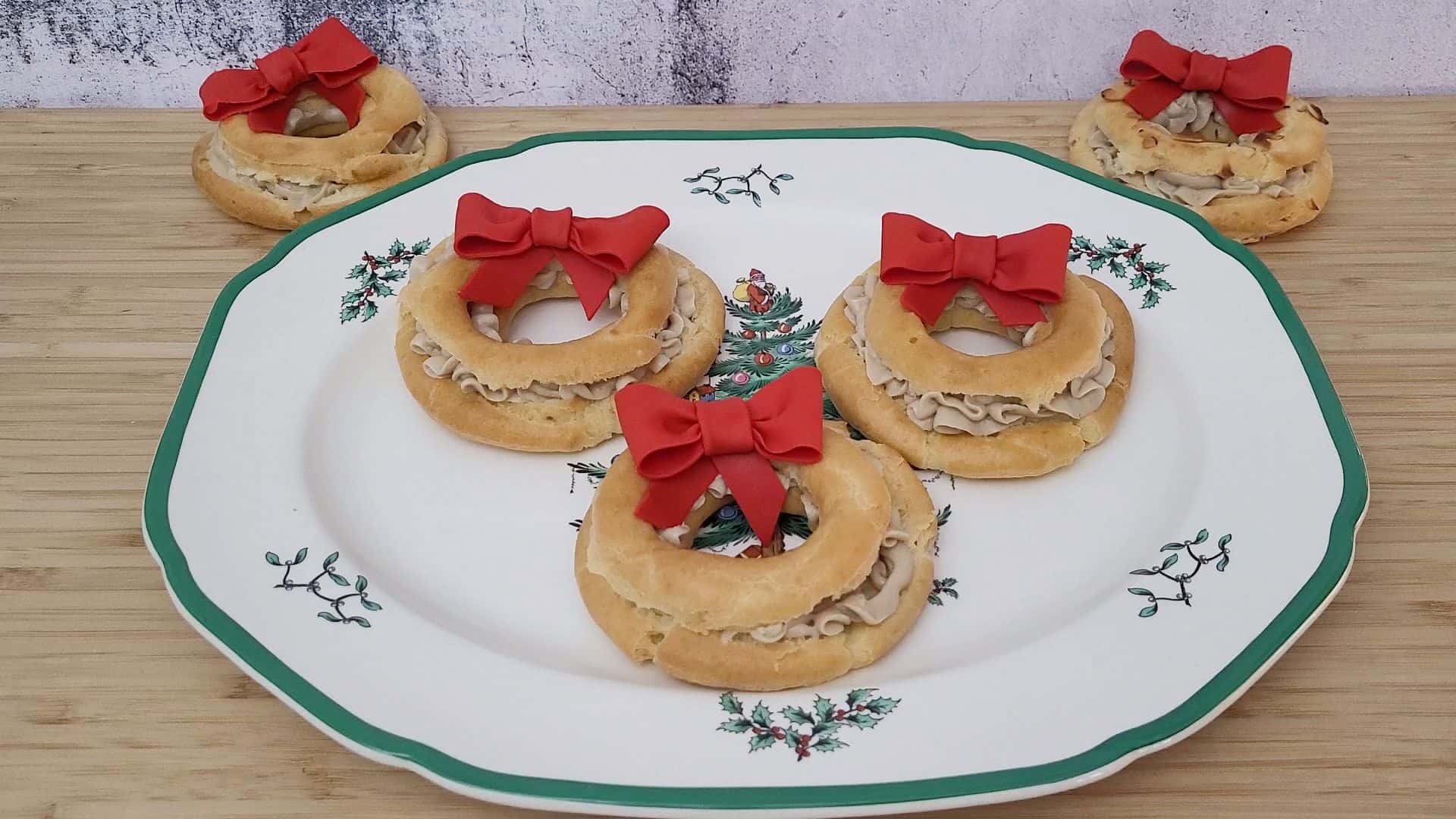 red bows on top of cream puffs on a Christmas plate