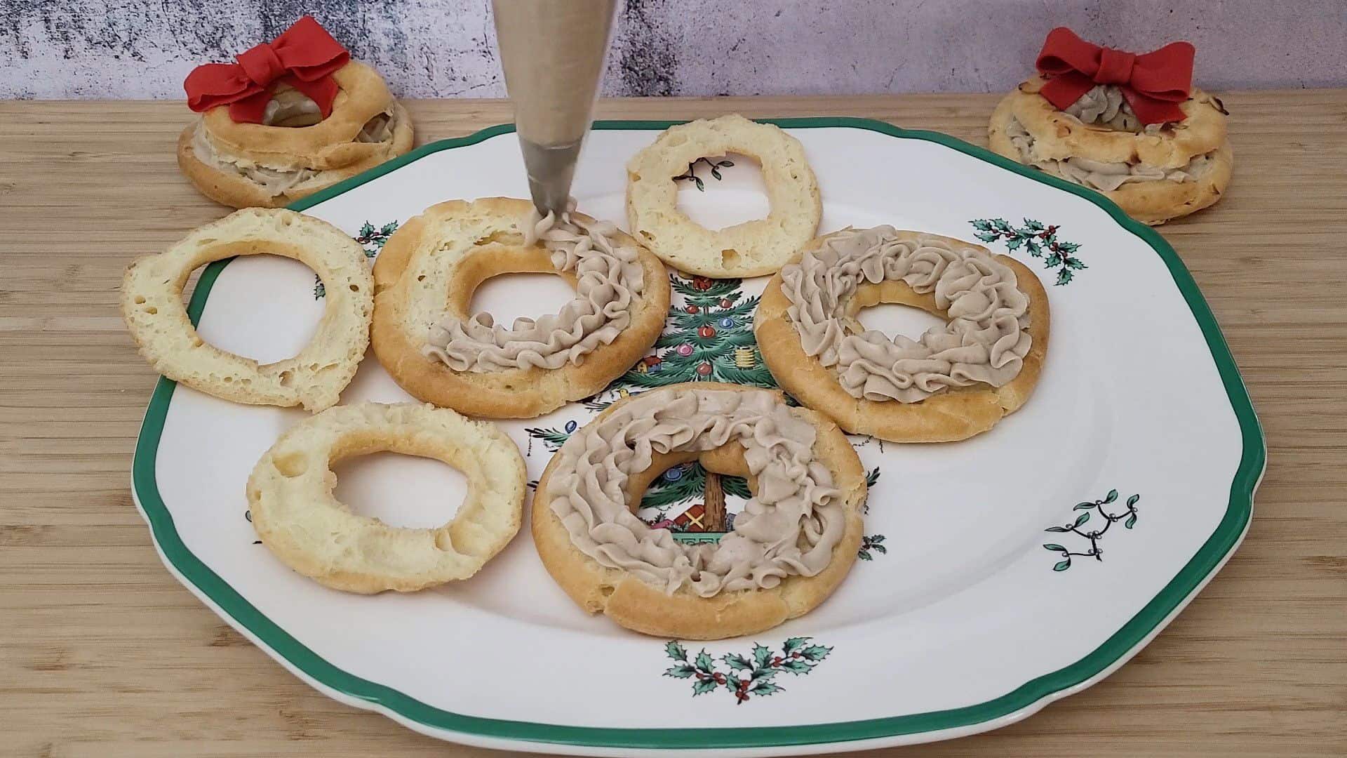 filling three cream puffs with pastry cream