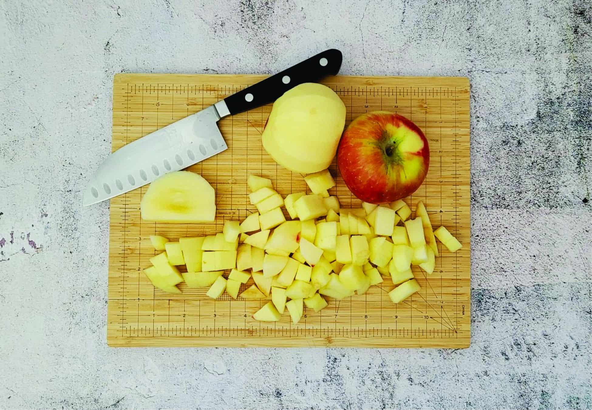 apples chopped into small pieces on a cutting board