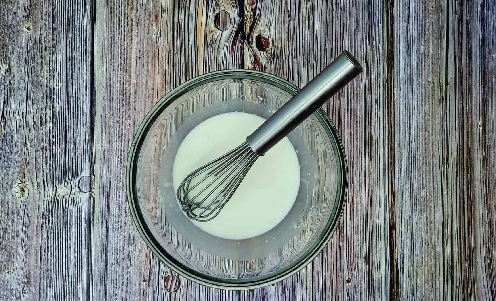 combining cornstarch and milk in a glass bowl