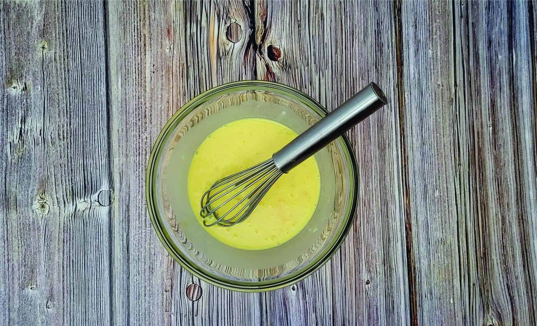 whisking eggs, cornstarch and milk in a glass bowl