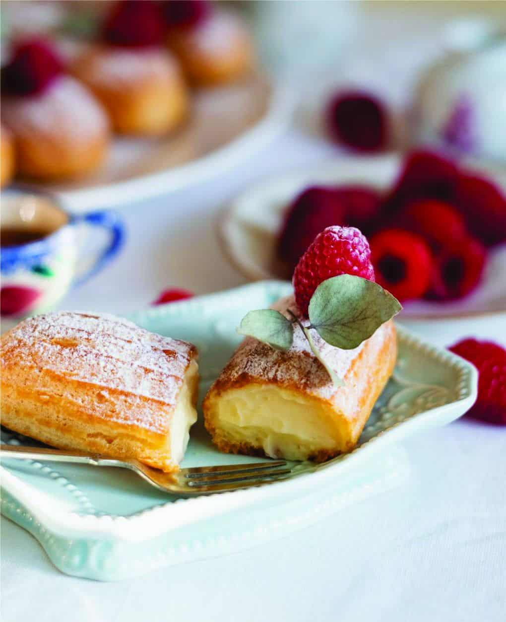 cream puff with vanilla pastry cream with raspberry garnish