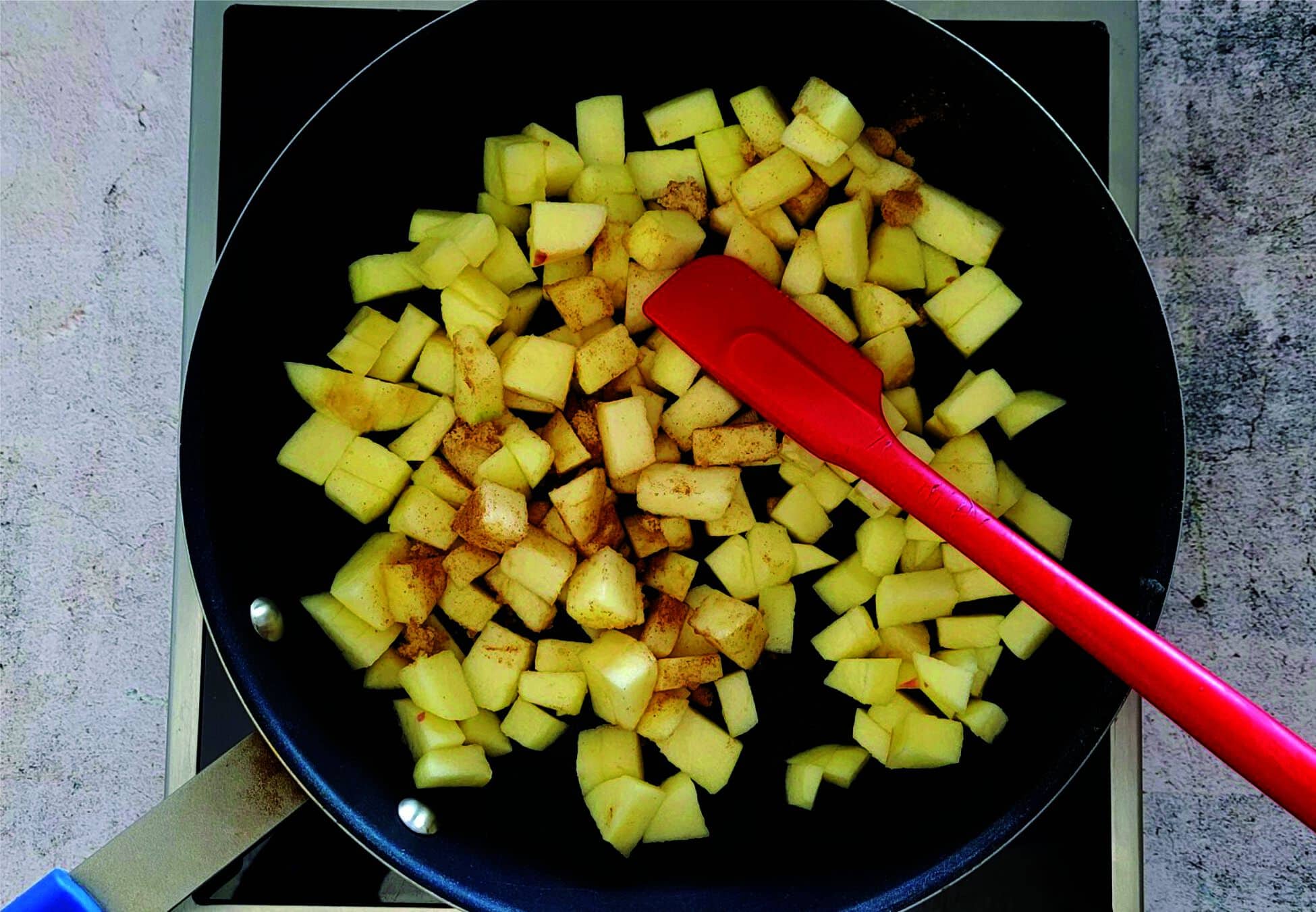 heating apples in a saucepan with sugar and spices