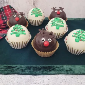 Hot chocolate bombs decorated as Rudolf and Christmas trees some with white chocolate and some with dark chocolate
