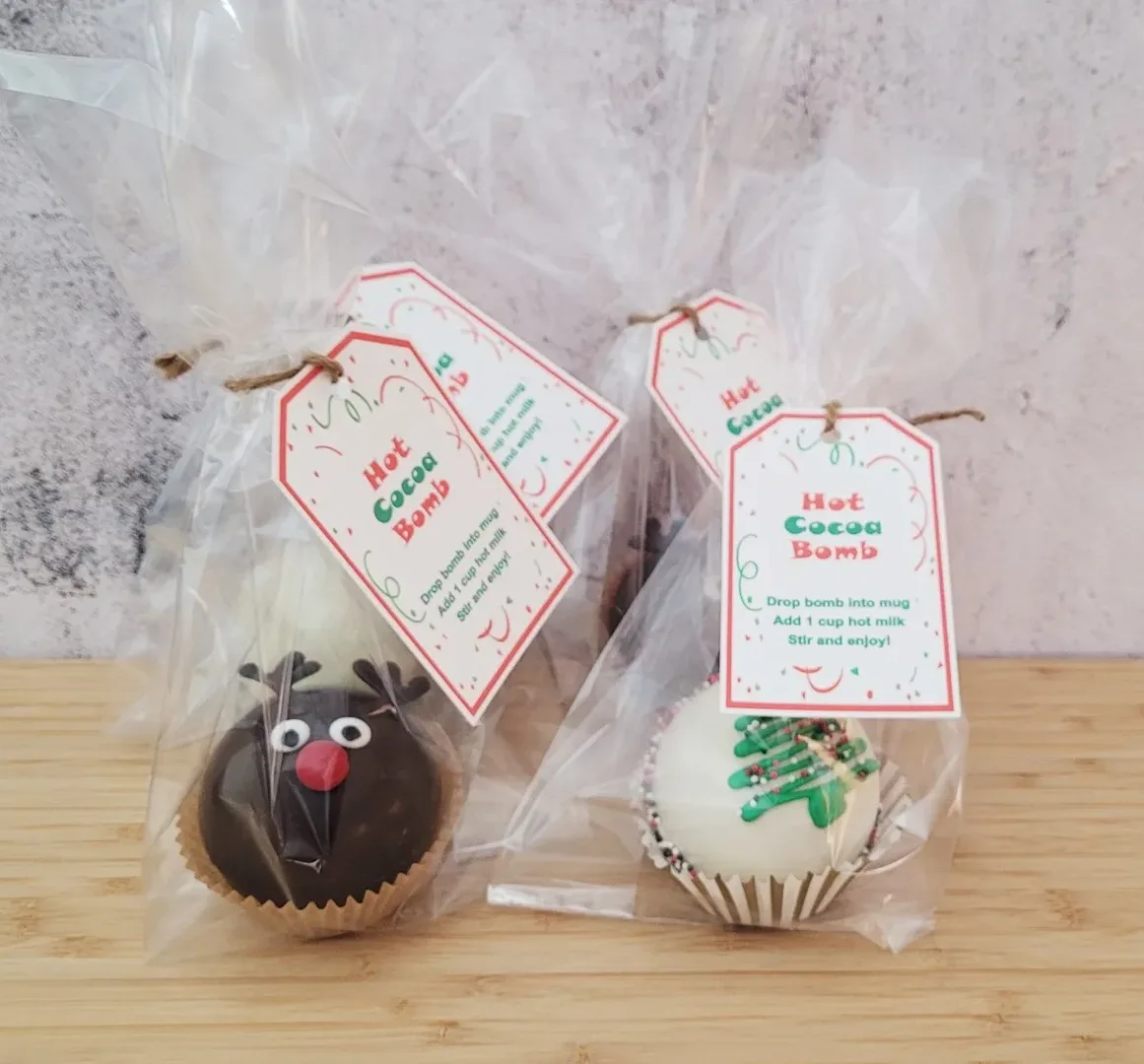 four hot chocolate bombs in cello bags and gift tags with instructions