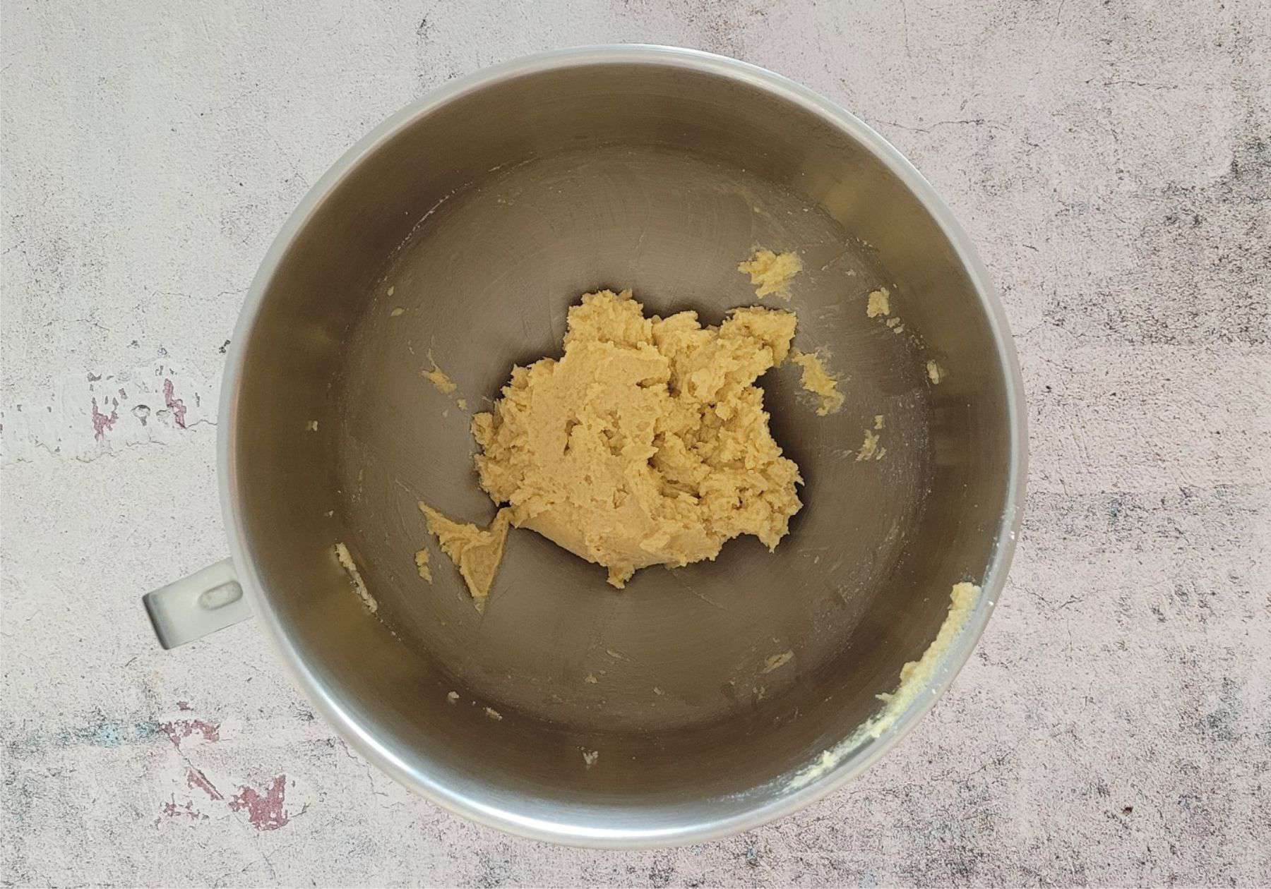cookie dough in a mixing bowl after adding the egg