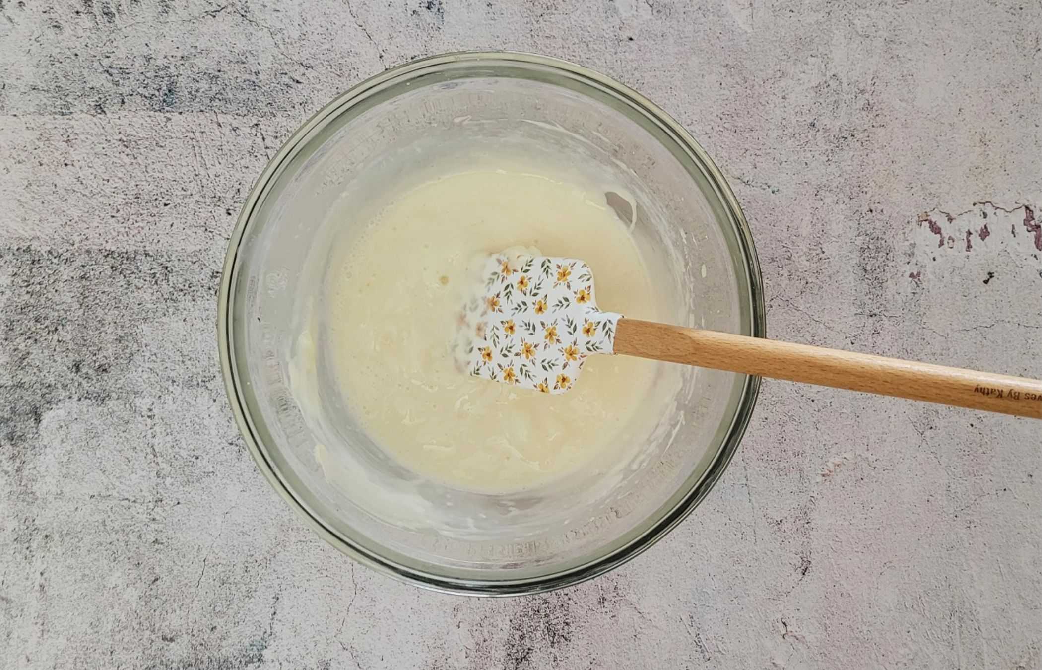 melted gelatin being stirred into mixture to make cream cheese mousse filling