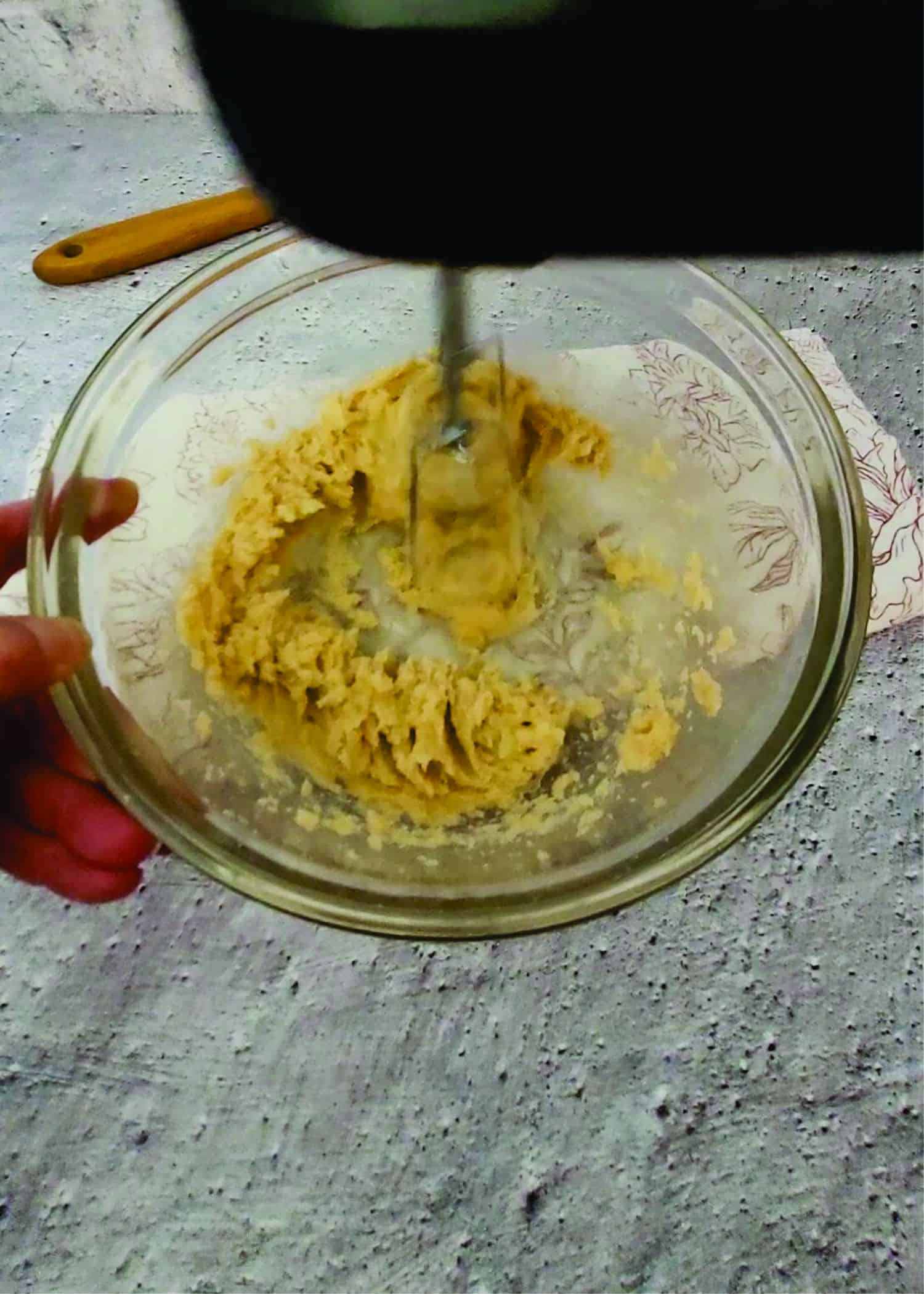 creaming butter and sugars together with a hand mixer to start cookie dough