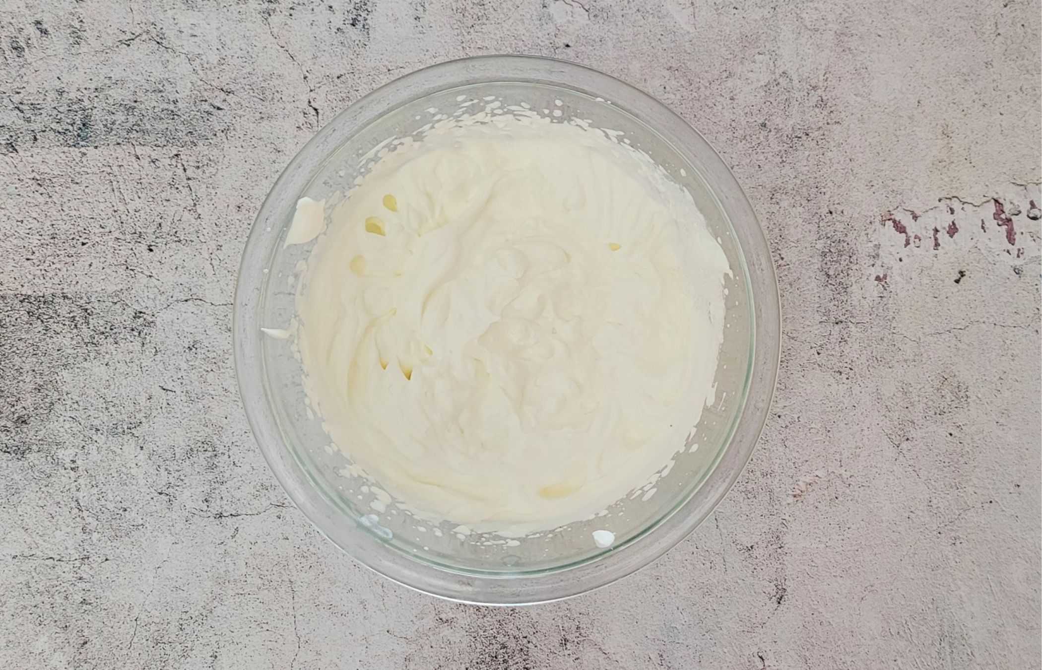 overhead view of a bowl with cream whipped to medium peaks