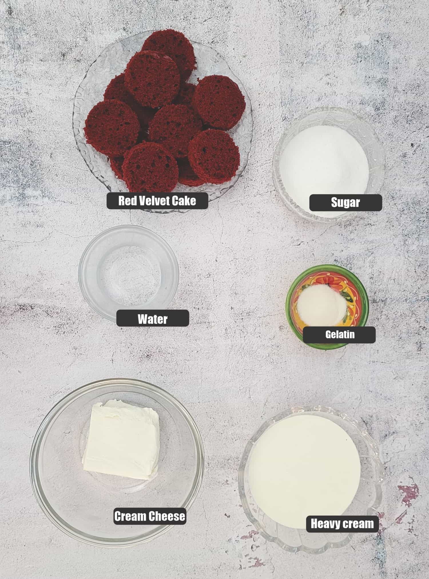 ingredients needed to make the red velvet bombes including cream, red velvet cake, cream cheese, sugar, water and gelatin