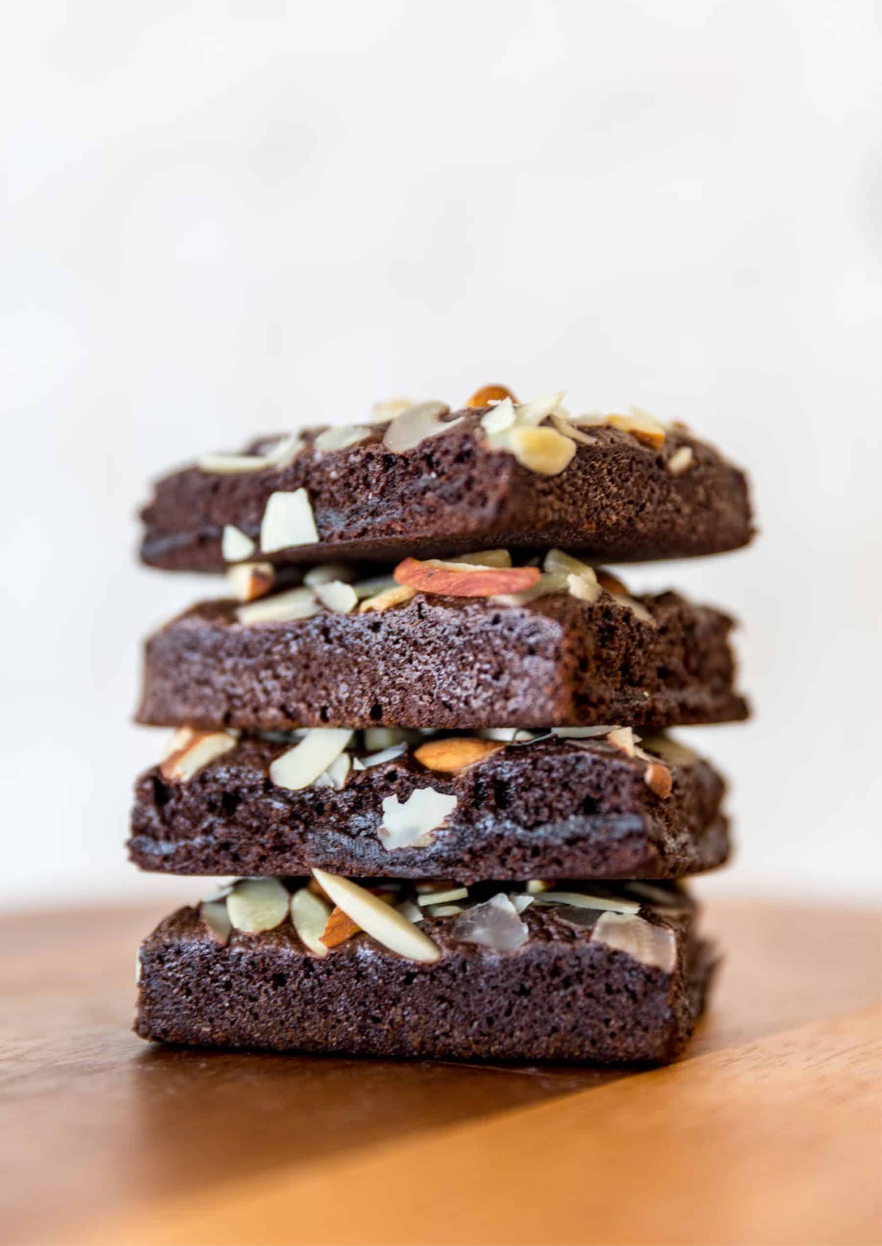 stack of four brownie pieces with nuts on top