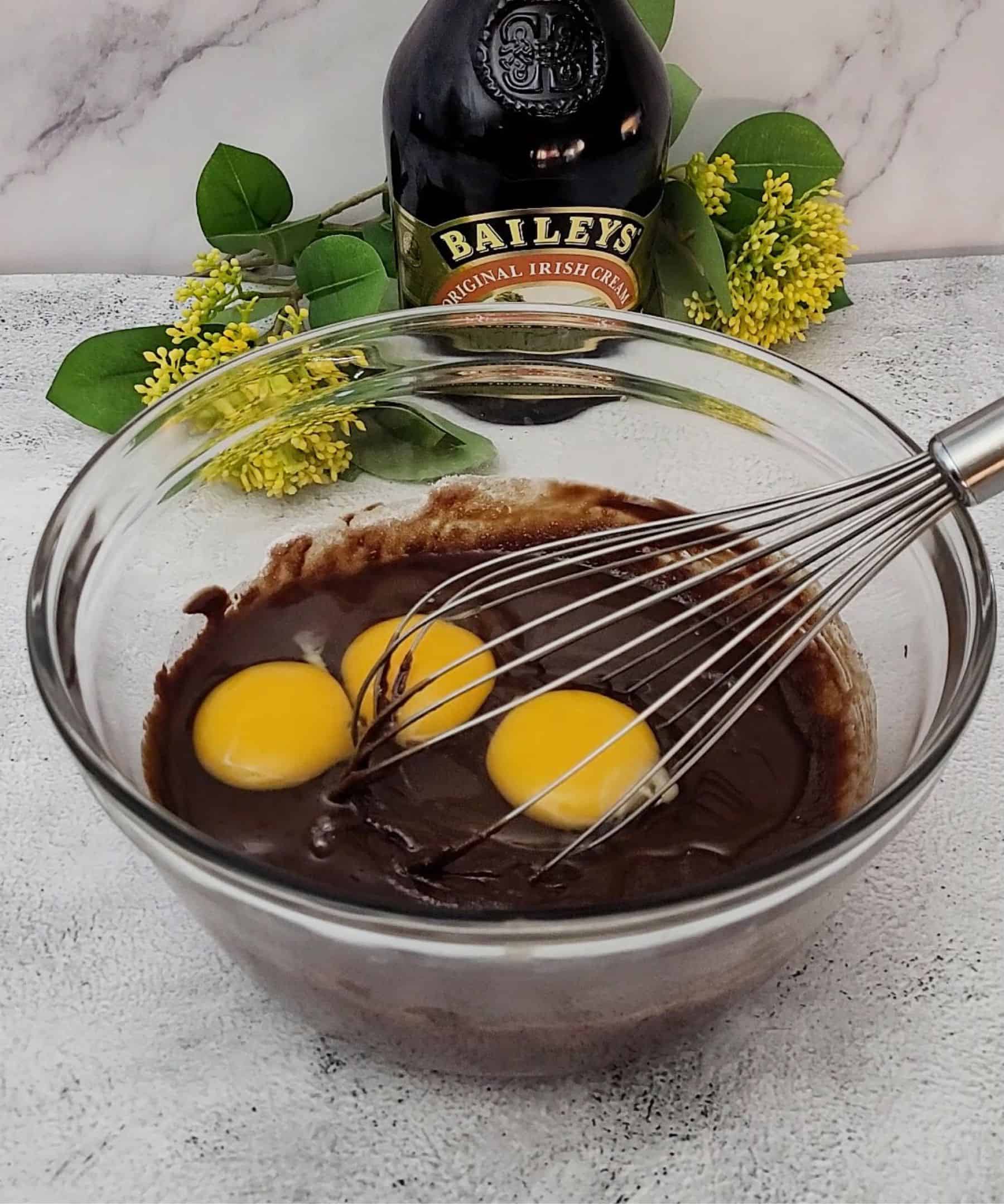 eggs added to bowl of chocolate cake batter