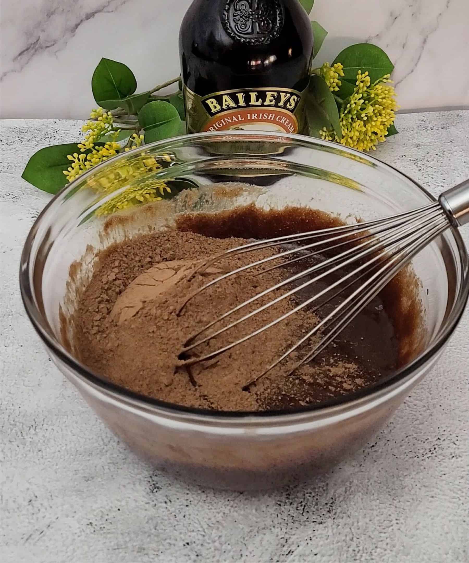 cocoa powder added to bowl of flourless chocolate cake batter