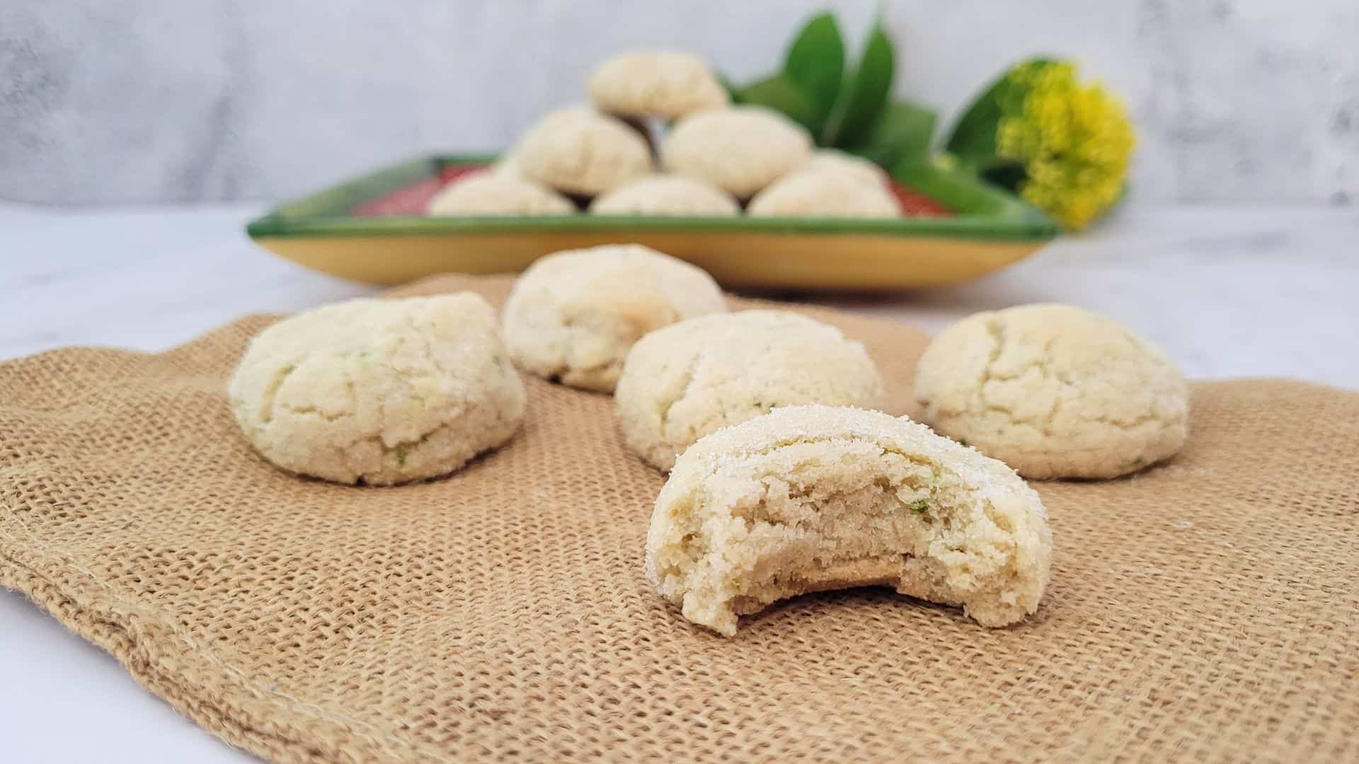 gluten free lime cookies with one cookie bitten into to show the soft inside